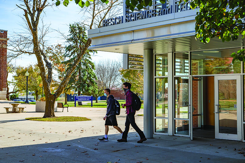 Masked students exit the Resch Science and Technology Hall