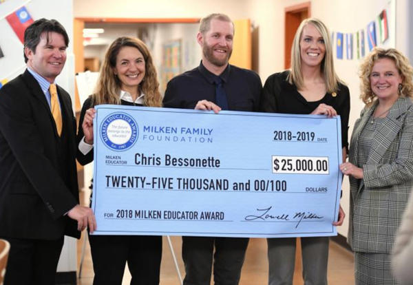 Bessonette and others holding oversized check for $25,000.