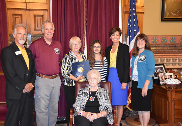 Shirley Kessel and group at Iowa State Capitol receiving award with Gov. Kim Reynolds