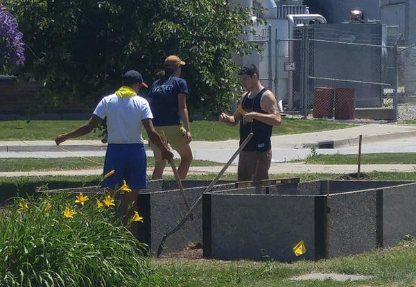 Men from the Lamoni and Graceland communities preparing raised garden beds