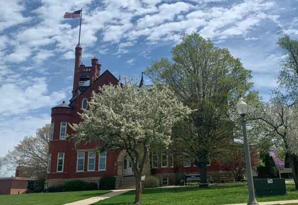 The Higdon Administration Building with spring blossoms on trees