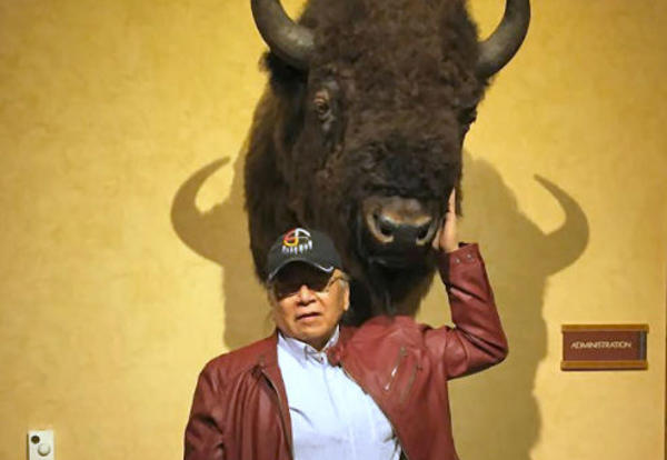 Ray Slick poses with a stuffed buffalo head.