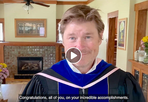 Dean of the College of Liberal Arts and Sciences Brian White shown in a paused moment of the graduation video