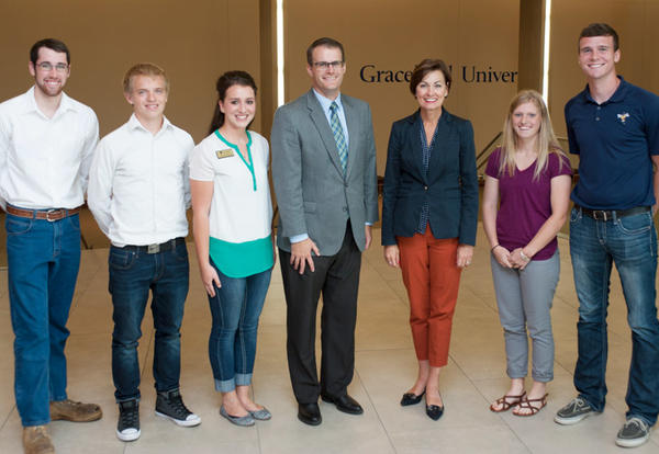 Several Graceland students pose for a photo opt with Iowa Governor Kim Reynolds and Lieutenant Governor Adam Gregg