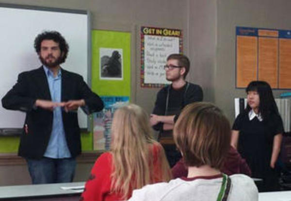 Professor Tim Robbins and Graceland student Matt Moore address a high school English class
