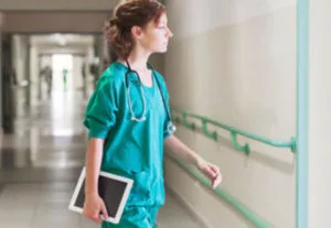 alt="Photo of a nurse in a hospital setting"