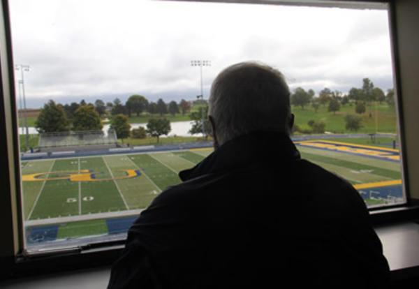 Retired Graceland sports announcer Joe Shelton looks out over Huntsman Field from the announcers box