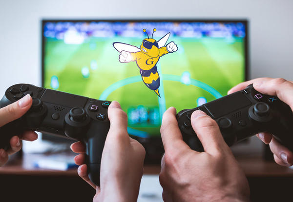 Hands holding two gaming controllers in front of TV with Sting logo