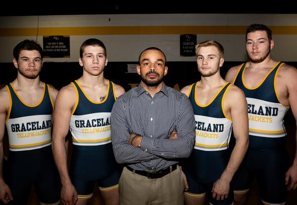 Four national-qualifying wrestlers with head coach Zack Mullins