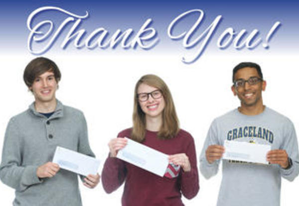 Three Graceland students display their micro scholarships as a thank you to the alumni donor who made it possible
