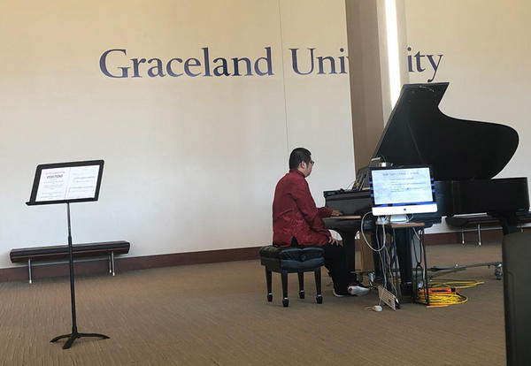 Dr. Yimmy plays "Vexation" on the piano in the Shaw Lobby
