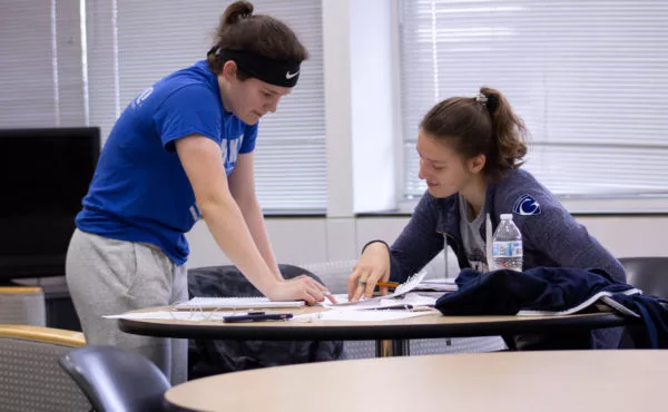 Two students reviewing an assignment