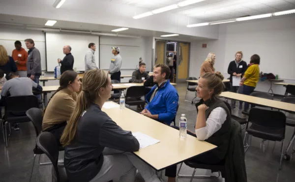 Students and alumni meeting in a group