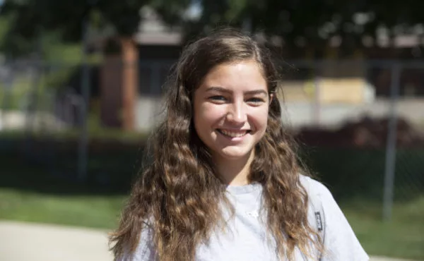 student smiling outside