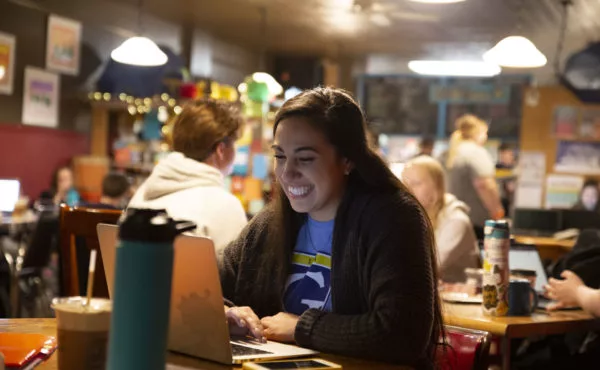 Young woman smiling at coffee shop