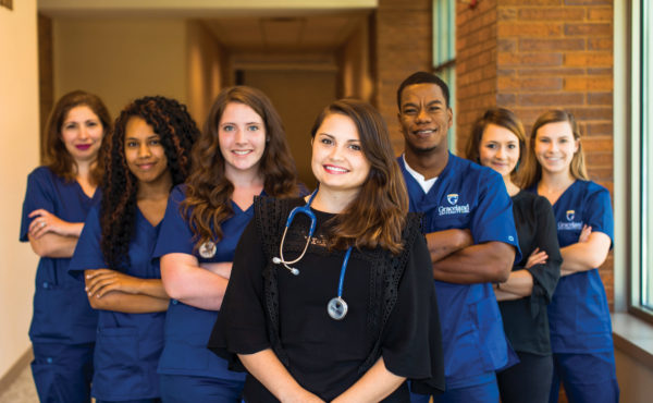 smiling nursing students pose together