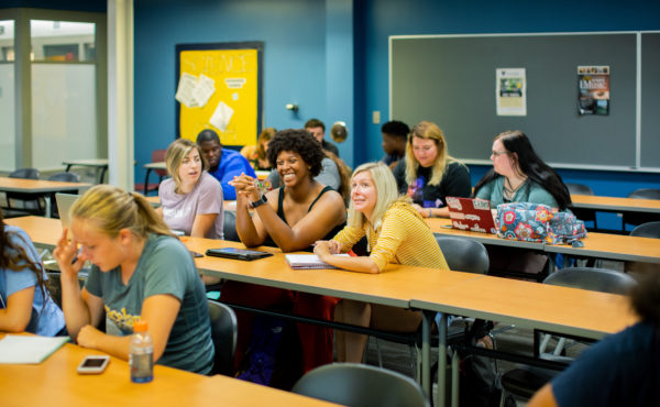 Students sit together in class and talk