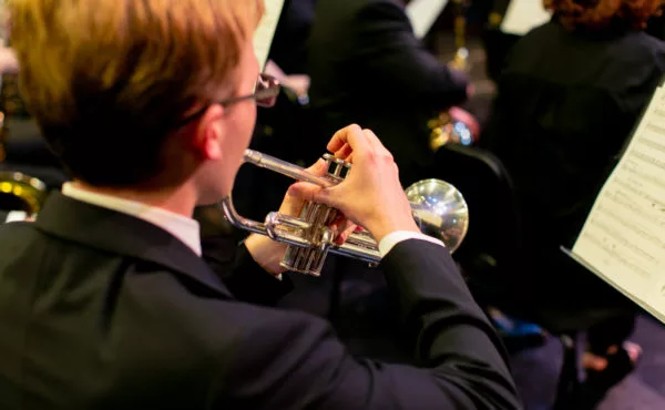 music student plays trumpet during symphonic band concert