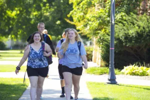 smiling students walking together outside HIgdon Ad Building