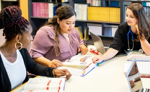 nursing students studying together in library