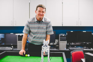 IT faculty smiles in classroom