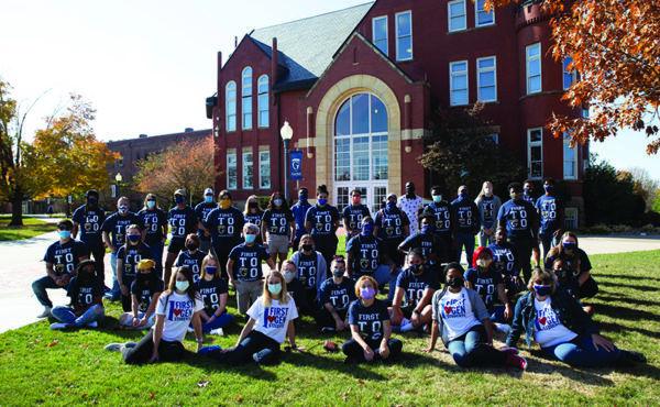 Group of students in matching shirts on college quad