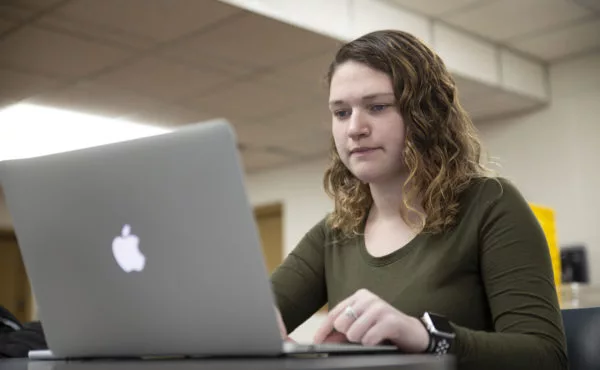 Female student using computer in basement library