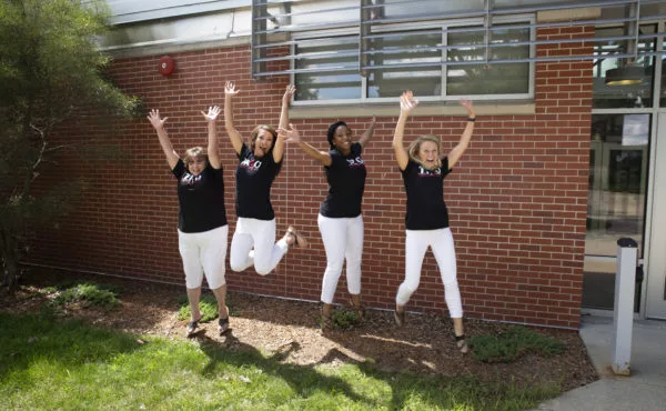 TRIO staff jump in air