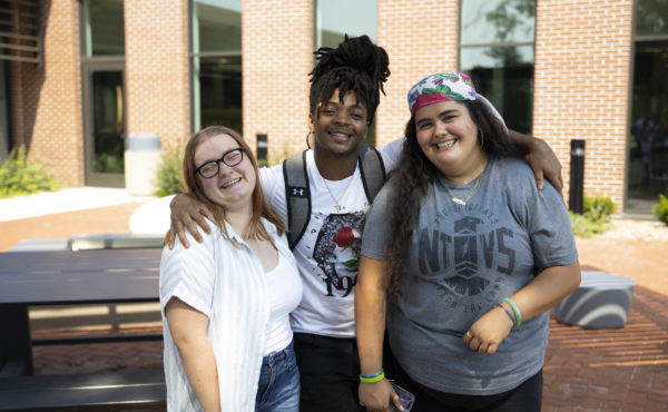 Students enjoy a summer afternoon in front of the Newcom Student Union