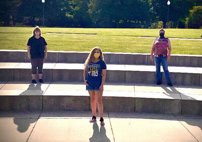 Photo of Naomi, her mother and Tracy Salter in the Shaw Amphitheater socially distanced with masks.