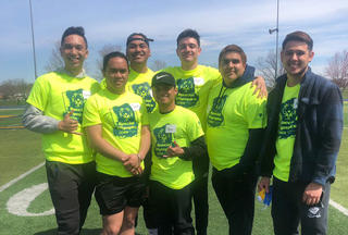 A group of volunteers from Graceland Men's Volleyball pose in their Special Olympics volunteer shirts.