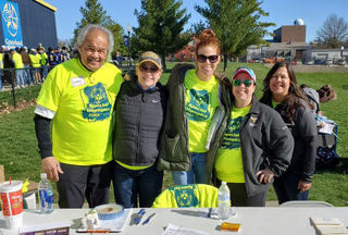 A group of Graceland staff volunteers pose for a photo in their Special Olympics volunteer shirts.