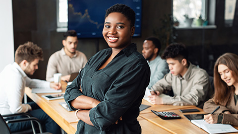 Smiling African American woman leads a group dicussion.